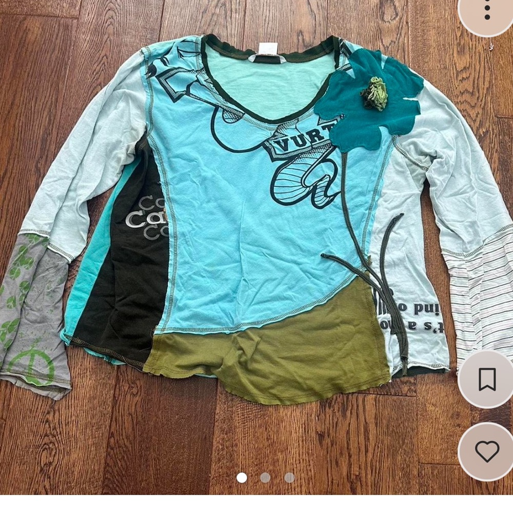 Asymmetrical stitched top with blue green and white highlights